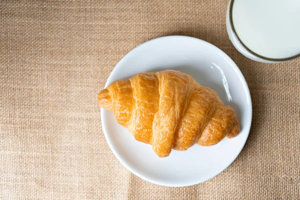 Croissants und Milch auf dem Tisch. — Stockfoto