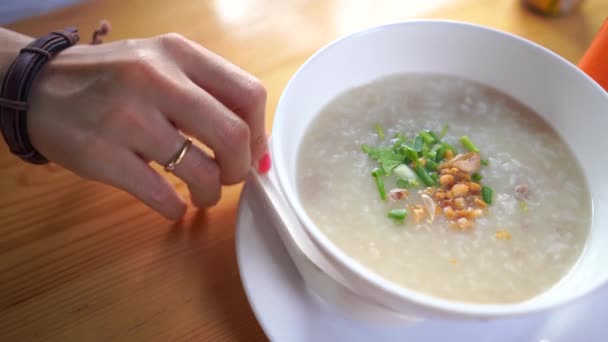 Hands Scooping Rice Soup — Stock Video