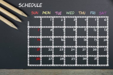 Kılavuz zaman masaya Siyah Kara tahta arka plan ile zamanlama