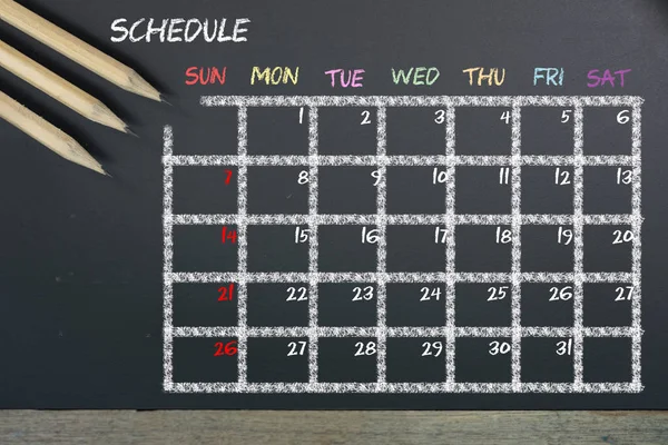 Schedule with grid time table on black chalkboard background — Stock Photo, Image