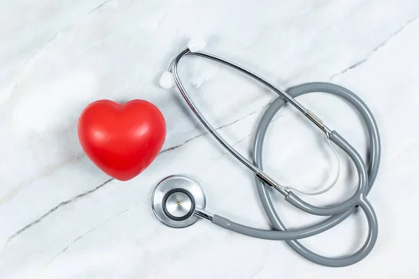 Stethoscope with heart on table background.  Heath care concept.