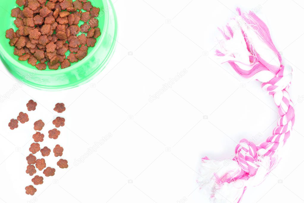 Dry food with pet accessories on isolated white background.