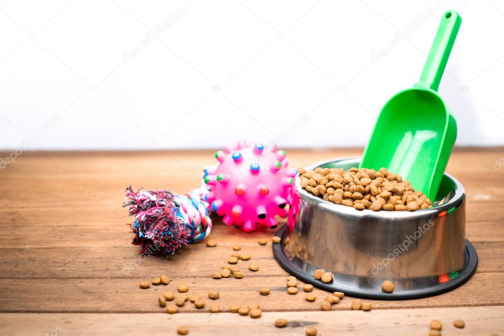 Pet food with accessories on wooden table.  Dry food for dog 