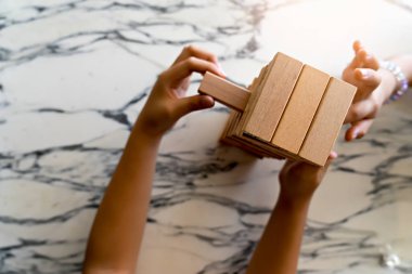 Hand kid playing wooden block for relax