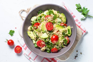 Quinoa salata ıspanak, avokado ve domates ile üst görünümü.