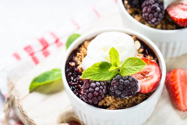 Crumble pie with berry mix, granola and ice cream.