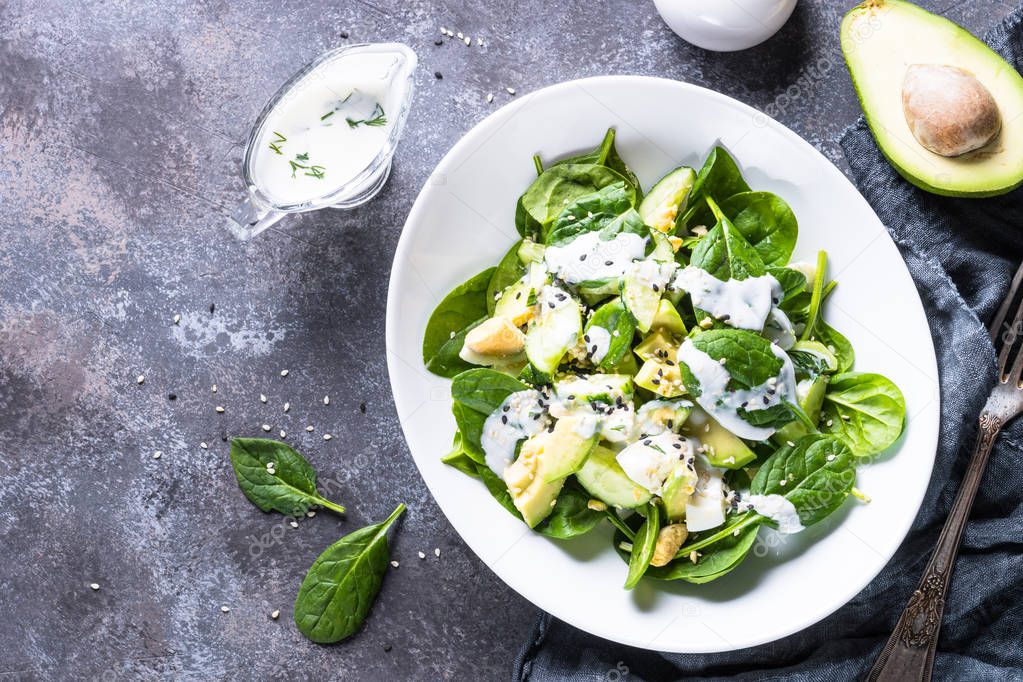 Green salad with avocado, spinach egg and cucumber. 