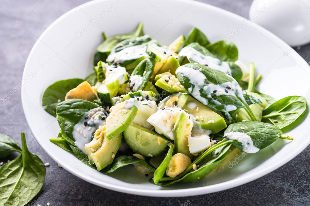 Green salad with avocado, spinach egg and cucumber. 