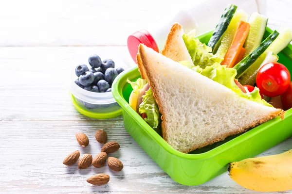 Pranzo al sacco con panino, verdure, banana, acqua, noci e ber — Foto Stock