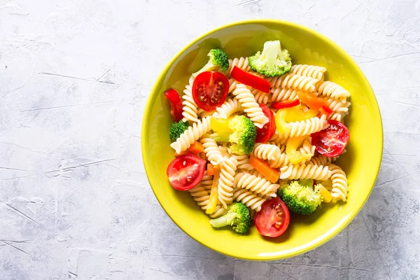 Vegan pasta fusilli with vegetables. Top view.