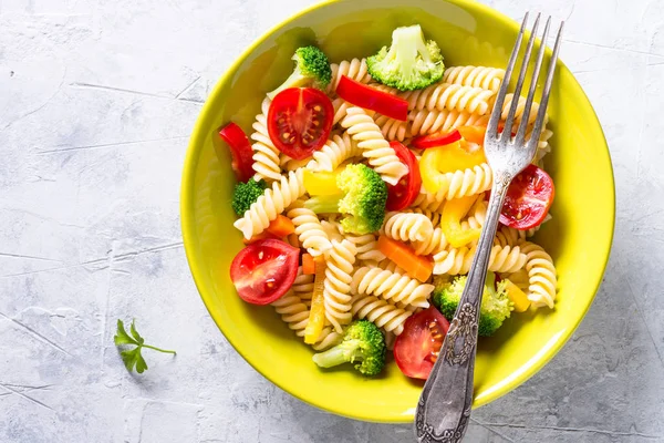 Vegan pasta fusilli with vegetables. Top view.