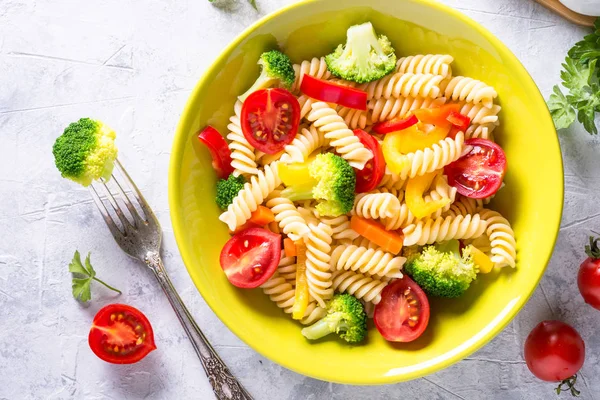 Vegan pasta fusilli with vegetables. Top view.