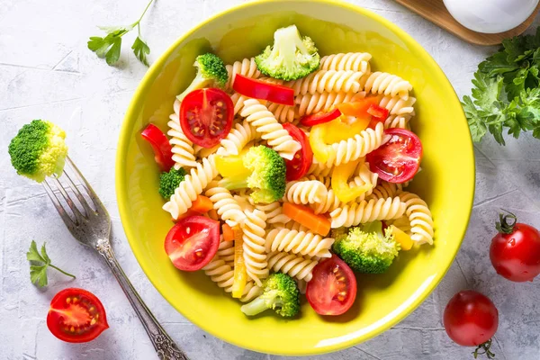 Vegan pasta fusilli with vegetables. Top view.