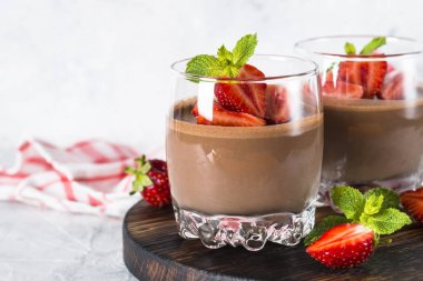 Chocolate dessert of whipped cream and strawberries in glass. clipart
