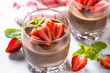 Chocolate dessert of whipped cream and strawberries in glass. clipart