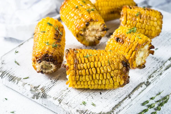 Grilled corn with spices on white board. — Stock Photo, Image