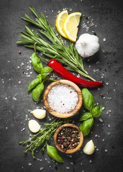Selection of spices and herbs  on dark stone table. — Stock Photo, Image