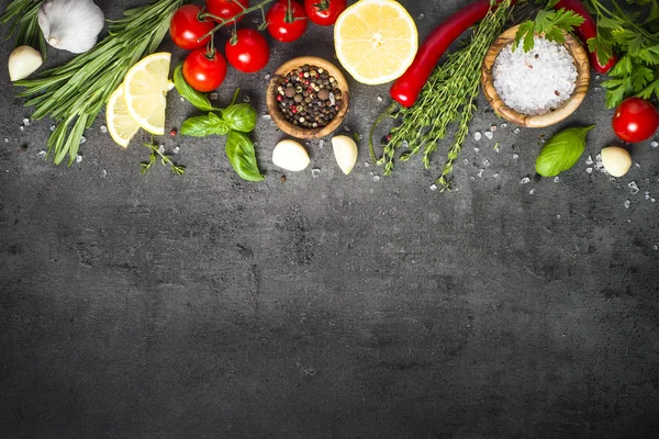 Selection of spices herbs and vegetables on black top view. — Stock Photo, Image