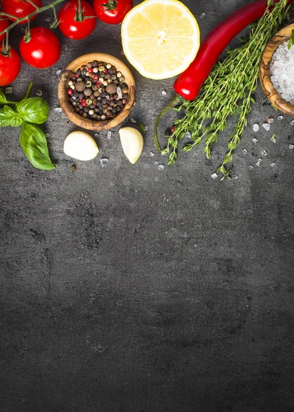 Selection of spices herbs and vegetables on black top view. — Stock Photo, Image