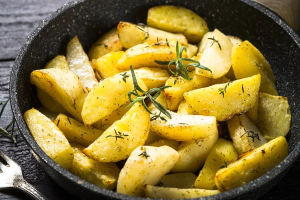 Pečené brambory s bylinkami v pánvi. — Stock fotografie