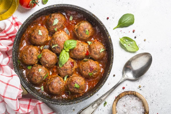 Meatballs in tomato sauce on white table. — Stock Photo, Image