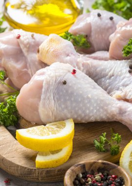 Çiğ tavuk sopaları ile yemek pişirmek için malzemeler kesme tahtası üzerinde.