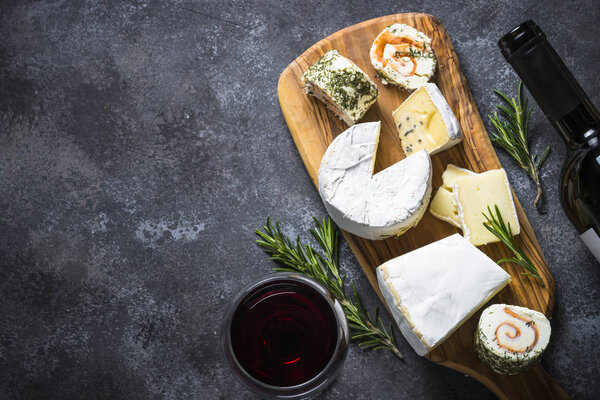 Cheese platter on dark stone table.