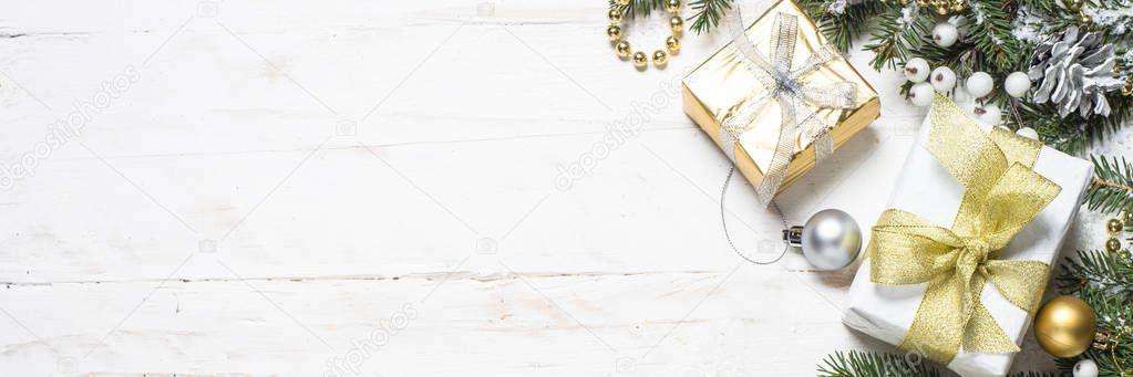 Christmas background with gold and silver decorations on white.