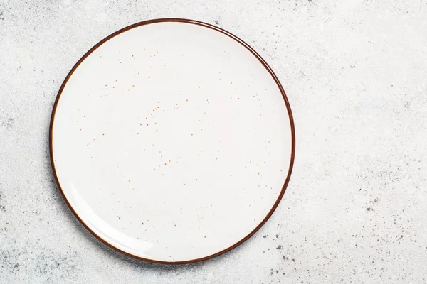 White craft plate on white stone table top view. — Stock Photo, Image