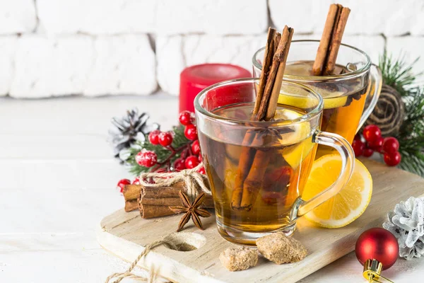 Christmas hot tea with lemon, spices and decorations — Stock Photo, Image