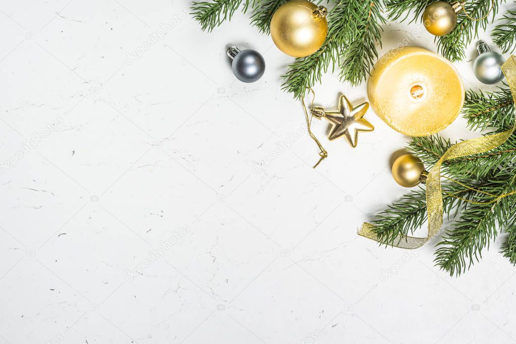 Gold  candle and decorations with fir tree on white  background.