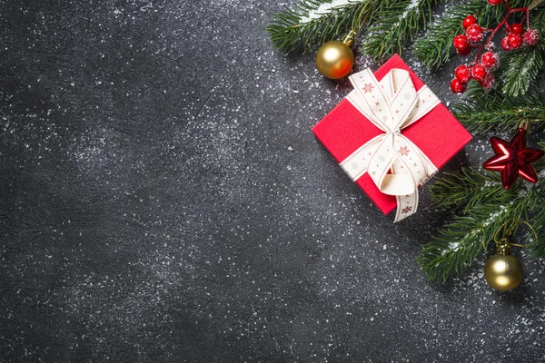 Red present box and decorations on black flat lay. — Stock Photo, Image