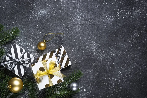 Christmas background with gold and silver decorations on black