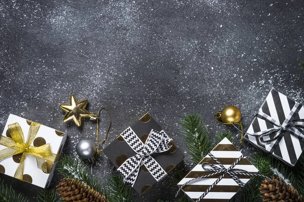 Christmas background with gold and silver decorations on black