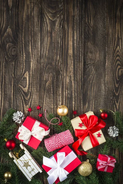 Christmas present box and decorations on dark wooden table. — Stock Photo, Image