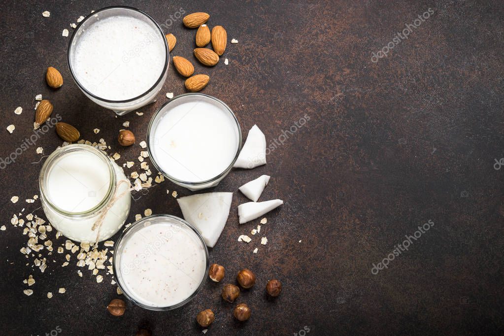 Vegan non dairy alternative milk, nuts and oat milk top view. 