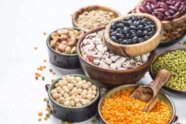 Legumes, lentils, chikpea and beans assortment on white. clipart