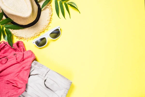 Woman summer cloth set - hat, top, shorts and sunglasses on yellow — Stock Photo, Image