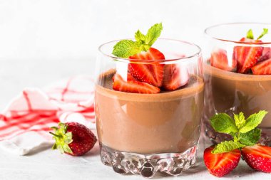 Chocolate panna cotta sweet dessert with strawberries in glass. clipart