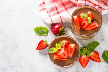 Chocolate panna cotta sweet dessert with strawberries in glass. clipart