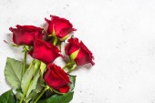 Red roses flower bouquet on white background top view. 