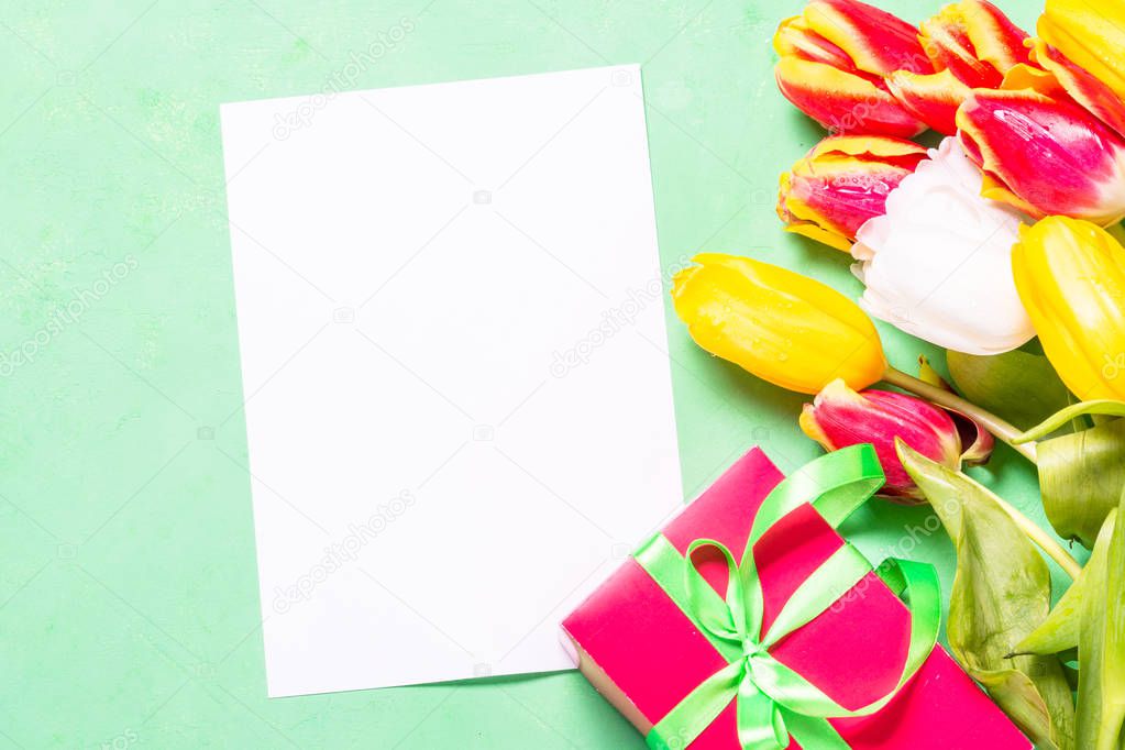 Flatlay flower holiday background. Tulips and paper.