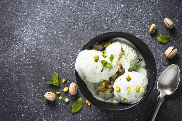 Pistazien-Eis in Schüssel auf schwarzem Stein-Tisch. — Stockfoto