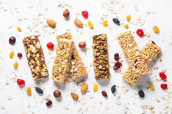 Granola bar with nuts, fruit and berries on white. — Stock Photo, Image