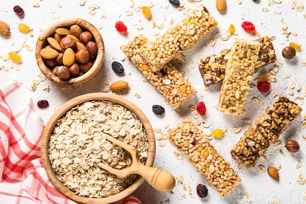 Granola bar with nuts, fruit and berries on white.