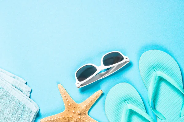 Blå flip flops, solglasögon och sjöstjärnor på blå bakgrund. — Stockfoto
