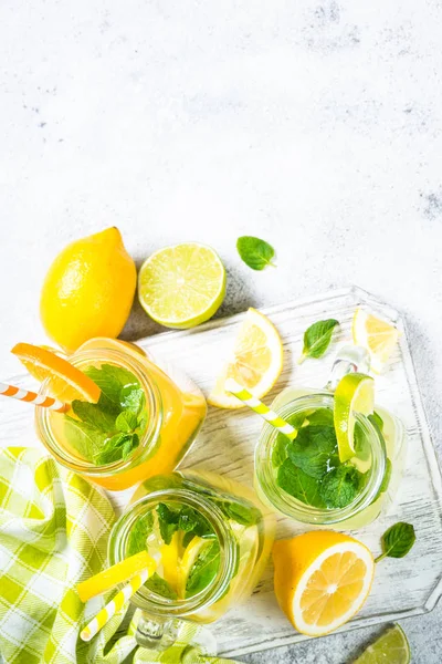 Lemonade, mojito and orange lemonade on white.