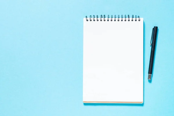 Notebook and pen on blue background. — Stock Photo, Image