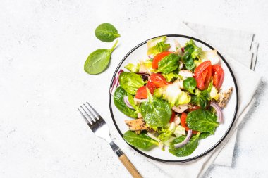 Beyaz üzerinde tavuk ve sebze ile yeşil salata.