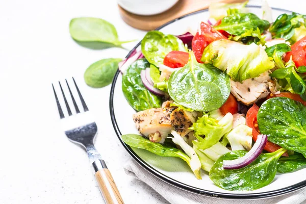 Green salad with chicken and vegetables on white. — Stock Photo, Image